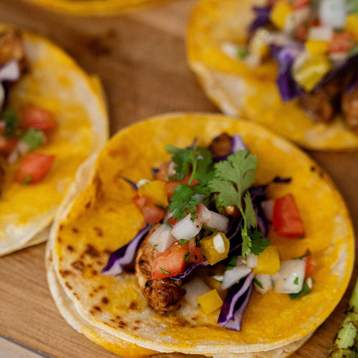 chicken tacos on a wood cutting board